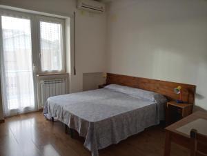 a bedroom with a bed and a large window at Gilda Vacanze Metro Battistini in Rome