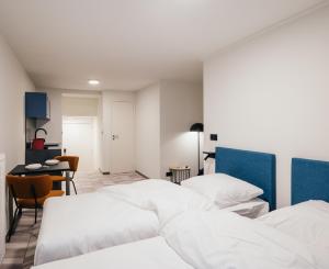 מיטה או מיטות בחדר ב-ROXI Residence Gent