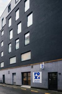 a large black building with a sign on it at ROXI Residence Gent in Ghent