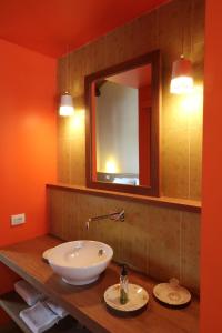 a bathroom with a sink and a mirror at Agriturismo Tetto Garrone in Cuneo