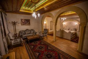 a living room filled with furniture and a stairway at Göreme Reva Hotel in Göreme