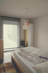 a bedroom with a large bed and a window at Zeewinde in Bredene