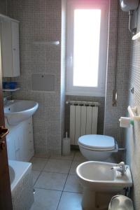 a bathroom with a sink and a toilet and a window at Gilda Vacanze Metro Battistini in Rome
