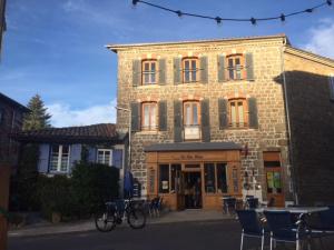 a bike parked in front of a brick building at Les Trois Temps in Saint-Didier-sur-Rochefort