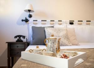 a white tray with a tea set on a bed at Agriturismo Tenuta Lagala in Venosa