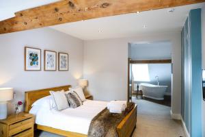 A bed or beds in a room at The Belfry Whitby 