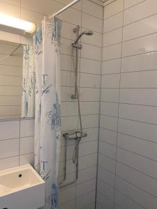 a bathroom with a shower with a shower curtain at EIDE Gjestehus in Eide