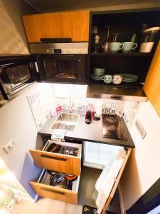 an overhead view of a small kitchen with a sink at Gites Spa Strasbourg - L'annexe in Furdenheim