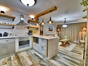 a kitchen with a large island and a living room at dk villas 4 Riverview, Hout Bay in Hout Bay