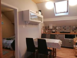 a kitchen and dining room with a table and chairs at Barbara Ház in Hévíz