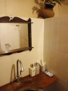 a bathroom with a sink and a mirror and a counter at Khmer Hands in Kep