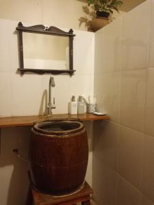 a bathroom with a sink and a mirror at Khmer Hands in Kep