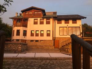 a large house with windows and a fence at Villa White Dove Sarajevo in Sarajevo