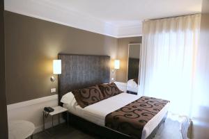 a hotel room with a bed and a window at Hotel Carla in Levanto
