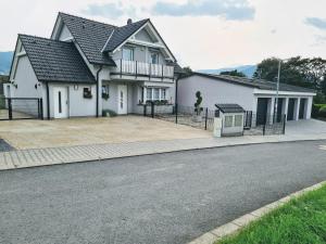 a large white house with a driveway at Dům Mnichov Bazén Klimatizace in Vrbno pod Pradědem