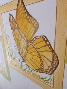 un dibujo de una mariposa en una caja de madera en Residence Celeste, en Mezzegra
