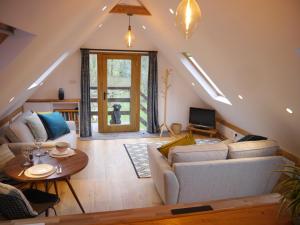 a living room with a couch and a table at The Studio @ Bridge Cottage in Totnes