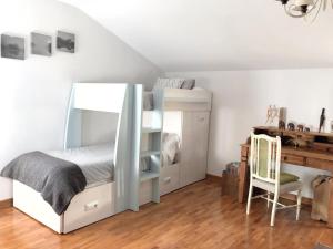 a bedroom with a bunk bed and a desk at La Aldaia de Urbasa in Eulate
