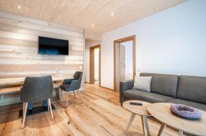 a living room with a couch and a table at Naturhaus am Arlberg in Warth am Arlberg