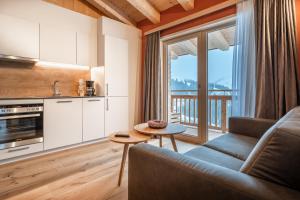 a living room with a couch and a large window at Naturhaus am Arlberg in Warth am Arlberg +62 photos
