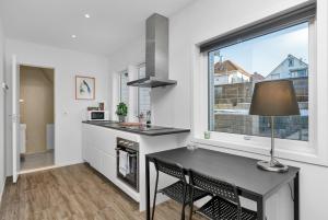 a kitchen with a table and a window at Central Studio Apartment Apt 102 in Stavanger