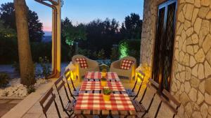 a table and chairs on the patio of a house at Cà RosannA in Rocca San Felice