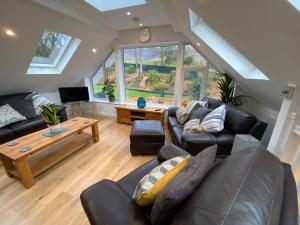 a living room with a couch and a table at Latrigg View in Keswick