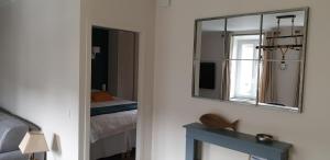 a room with a mirror and a bed and a bed sidx sidx sidx at Port de La Houle - Beau 2 pièces classé 3 étoiles avec stationnement in Cancale +58 photos