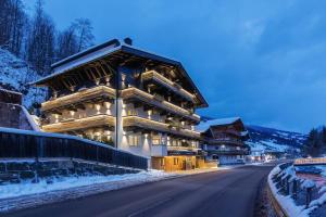 a large building on the side of a road at Boutique Hotel ANYBODY in Saalbach Hinterglemm