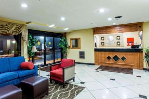 a lobby with a blue couch and two red chairs at Comfort Inn Columbia-Bush River in Columbia