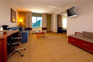 a living room with a couch and a tv at Comfort Inn Near Quantico Main Gate North in Dumfries