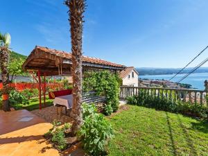 a backyard with a palm tree and a gazebo at Top view in Opatija