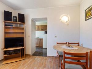 a living room with a dining room table and a television at Top view in Opatija