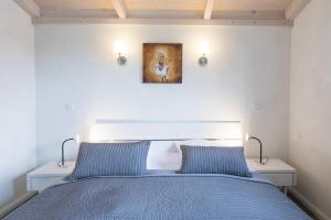 a bedroom with a blue bed with two blue pillows at Ferienhaus Strandkrabbe in Dagebüll