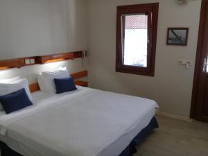 A bed or beds in a room at UzHan Beach Hotel