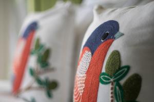a pillow with a peacock design on it at An Oasis in Tagaytay in Tagaytay