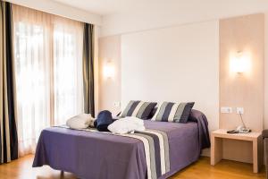 A bed or beds in a room at Sagitario Playa