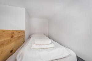 a small room with two beds with white sheets at JM Rooms Lubicz I in Krakow