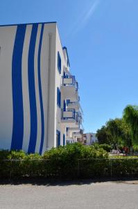 a building with blue and white stripes on it at Campitur in Campomarino