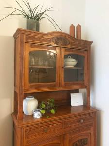 a wooden hutch with a vase on top of it at Appartement Rotterdam Noord in Rotterdam