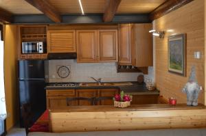 a kitchen with wooden cabinets and a counter top at BAITA SIBERIA in Craveggia