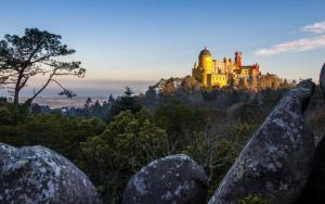 a castle on top of a hill with rocks at Bloom Cottage II in Sintra