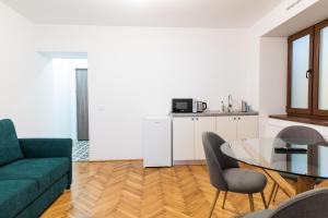a living room with a green couch and a glass table at Casa Postavarului in Braşov