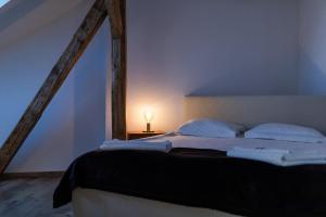 a bedroom with a bed and a lamp on a table at Casa Postavarului in Braşov