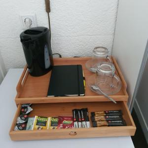 a wooden shelf with a coffee pot and books at Hotel The Ark in 't Zand