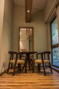 uma sala de jantar com uma mesa, cadeiras e um espelho em Termales Santa Rosa De Cabal em Santa Rosa de Cabal