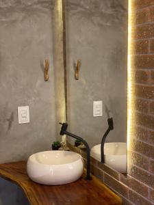 a bathroom with a sink and a mirror at Vila do Alto - Beach Homes in Itarema