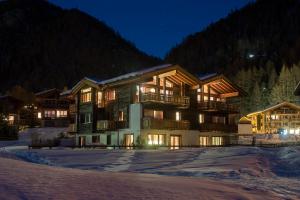 a large building in the snow at night at Chalet Shalimar in Zermatt