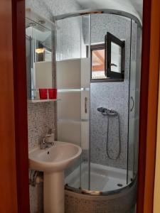 a bathroom with a shower and a sink at Apartments Angela in Žbandaj