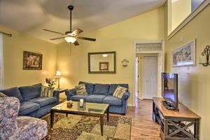 a living room with blue couches and a tv at Cocoa Beach Paradise with Indoor and Outdoor Fun! in Merritt Island